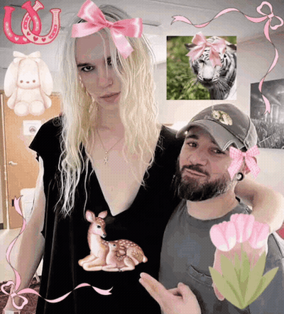 Woman With Pink Bow Next To Bearded Man GIF