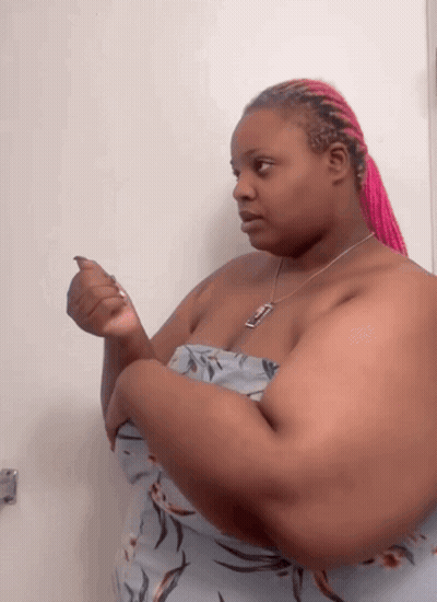 Woman With Pink Braids And Necklace With Letter T GIF