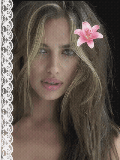 Woman With Pink Flower In Hair GIF