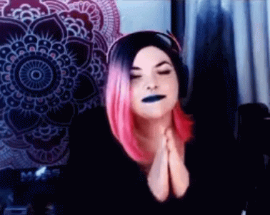 Woman With Pink Hair And Black Lipstick Praying GIF