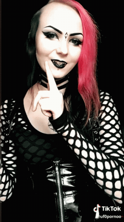 Woman With Pink Hair And Black Makeup In Black Top GIF