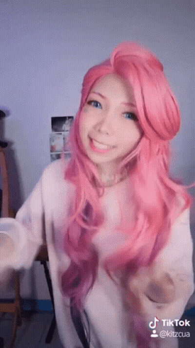 Woman With Pink Hair And Blue Eyes In White Shirt GIF