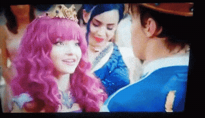 Woman With Pink Hair And Crown Talking To Man In Blue Suit GIF