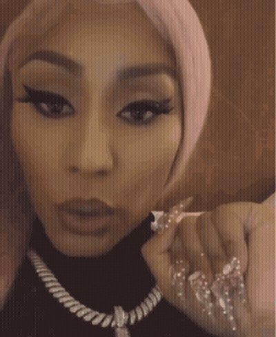 Woman With Pink Hair And Long Nails In Black Turtleneck GIF