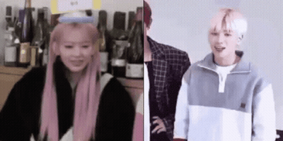 Woman With Pink Hair And Man With White Hair Standing Together GIF