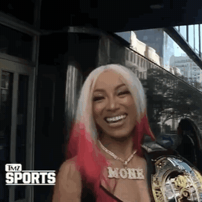 Woman With Pink Hair And Monk Necklace Smiling GIF