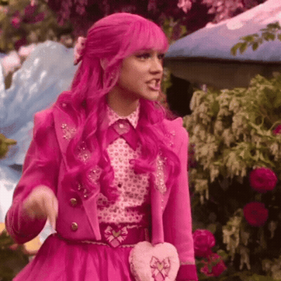 Woman With Pink Hair And Pink Jacket Holding Heart Purse GIF