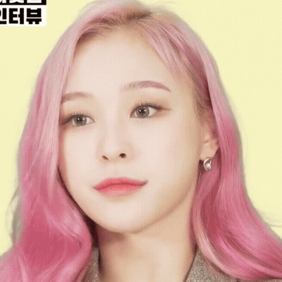 Woman With Pink Hair Close Up On Yellow Background GIF