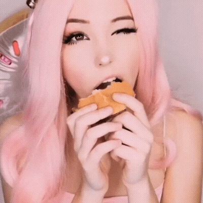 Woman With Pink Hair Eating Bitten Sandwich GIF
