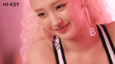 Woman With Pink Hair Hoop Earrings And B Necklace GIF