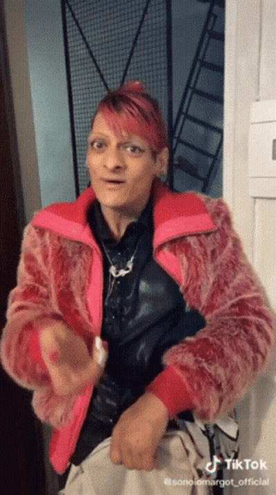 Woman With Pink Hair In Pink Fur Jacket GIF