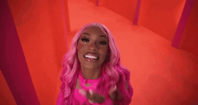 Woman With Pink Hair In Pink Top And Gloves GIF