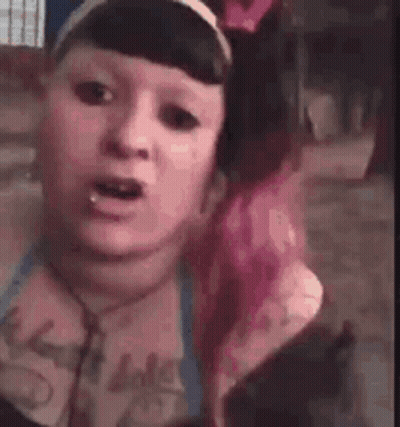 Woman With Pink Hair Making Funny Face Wearing Headphones And Headband GIF