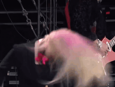 Woman With Pink Hair Playing Red Guitar GIF