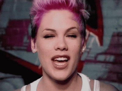 Woman With Pink Hair Smiling In White Tank Top GIF