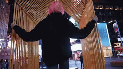 Woman With Pink Hair Standing In Front Of 666 Sign GIF