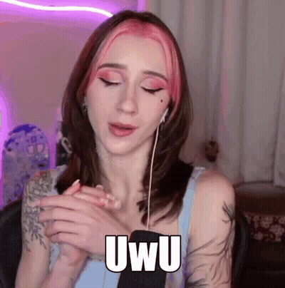 Woman With Pink Hair Wearing Ear Buds Saying Uwu GIF