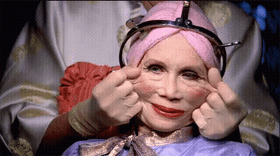 Woman With Pink Towel On Head Making Face GIF