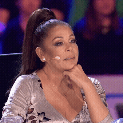 Woman With Ponytail At Microphone Hand On Chin GIF