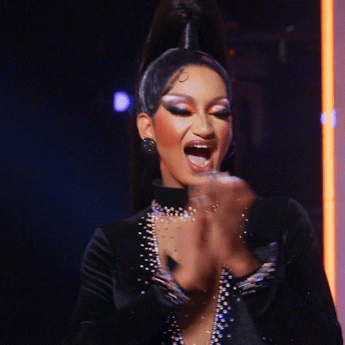 Woman With Ponytail Clapping Hands In Dark Room GIF