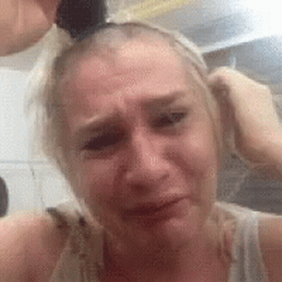 Woman With Ponytail Crying Holding Hair GIF