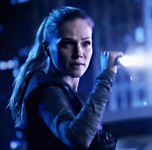 Woman With Ponytail In Dark Room With Blue Light GIF