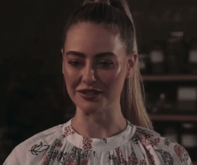 Woman With Ponytail In Floral White Top GIF