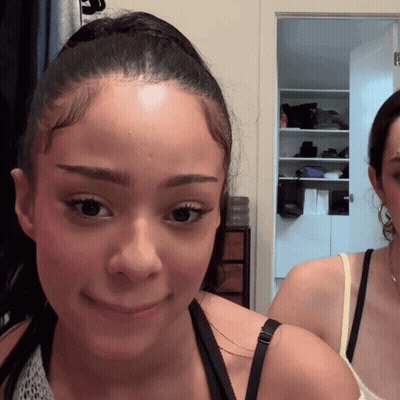 Woman With Ponytail Looking At Camera GIF