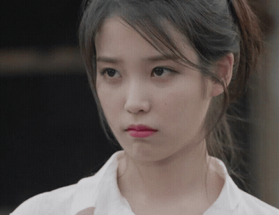 Woman With Ponytail Looking At Camera GIF
