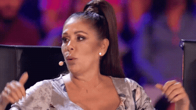 Woman With Ponytail Making Funny Face At Microphone GIF