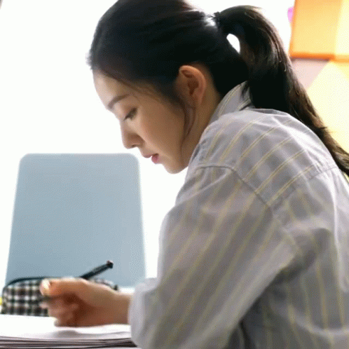 Woman With Ponytail Writing At Desk GIF
