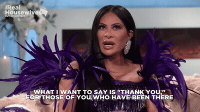 Woman With Purple Feathers Saying Thank You GIF
