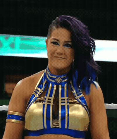 Woman With Purple Hair And Blue Eyes In Gold And Blue Top GIF