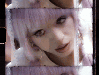 Woman With Purple Hair And Earrings GIF