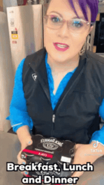 Woman With Purple Hair And Glasses Holding Food Box GIF