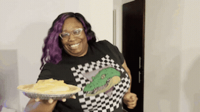 Woman With Purple Hair And Glasses Holding Pie GIF