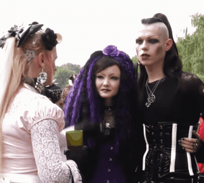 Woman With Purple Hair And Man With Mohawk GIF