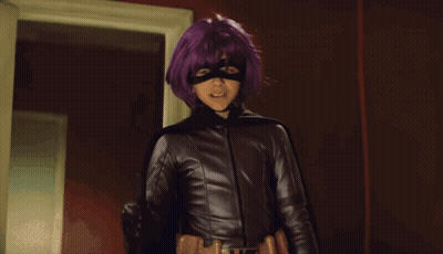 Woman With Purple Hair And Mask In Front Of Looking Sign GIF
