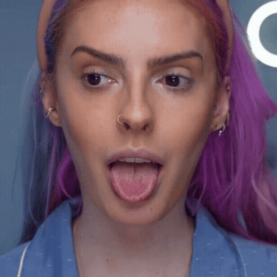 Woman With Purple Hair And Nose Ring Sticking Tongue Out GIF