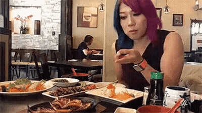 Woman With Purple Hair Eating At Restaurant GIF