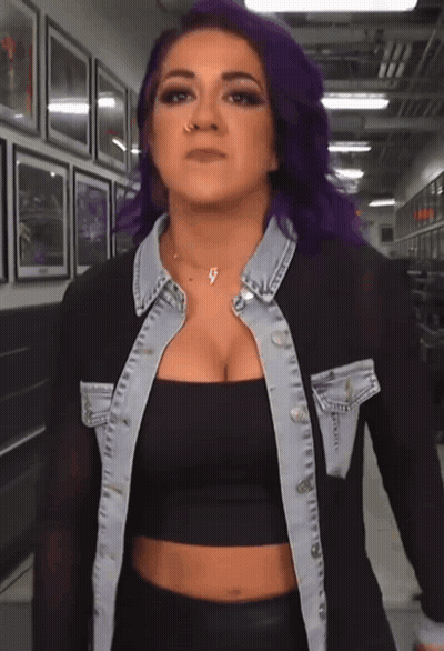 Woman With Purple Hair In Black Crop Top And Denim Jacket GIF