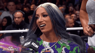 Woman With Purple Hair Sitting At Microphone GIF