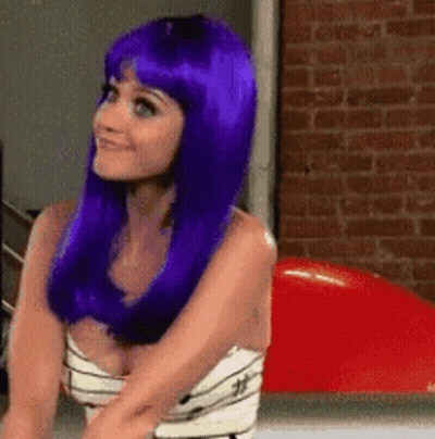 Woman With Purple Hair Sitting In Front Of Red Balloon GIF