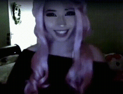 Woman With Purple Hair Smiling In Dark Room GIF