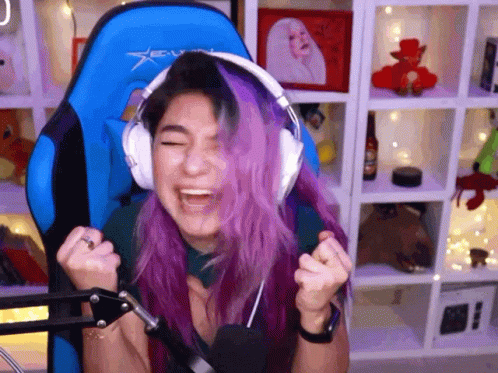 Woman With Purple Hair Wearing Headphones In Blue Chair GIF