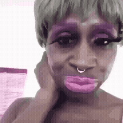 Woman With Purple Makeup Making Funny Face GIF