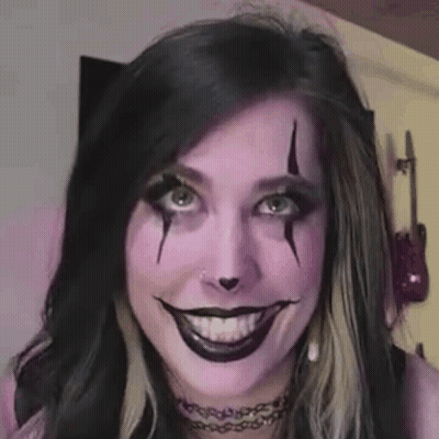 Woman With Purple Makeup Making Funny Face GIF
