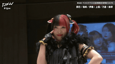 Woman With Red And Black Hair In Black Feather Boa And Gloves GIF