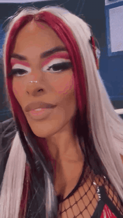Woman With Red And White Hair And Fishnet Top GIF