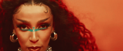 Woman With Red Background And Blue Eye Shadow GIF